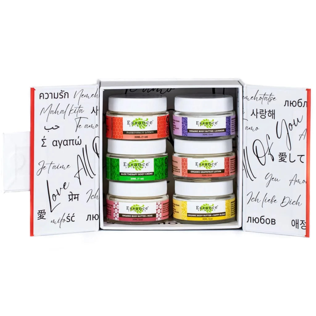 An open white gift box containing six small cosmetic jars arranged in two columns of three. The jars have white lids and colorful labels in orange, purple, green, pink, and yellow.