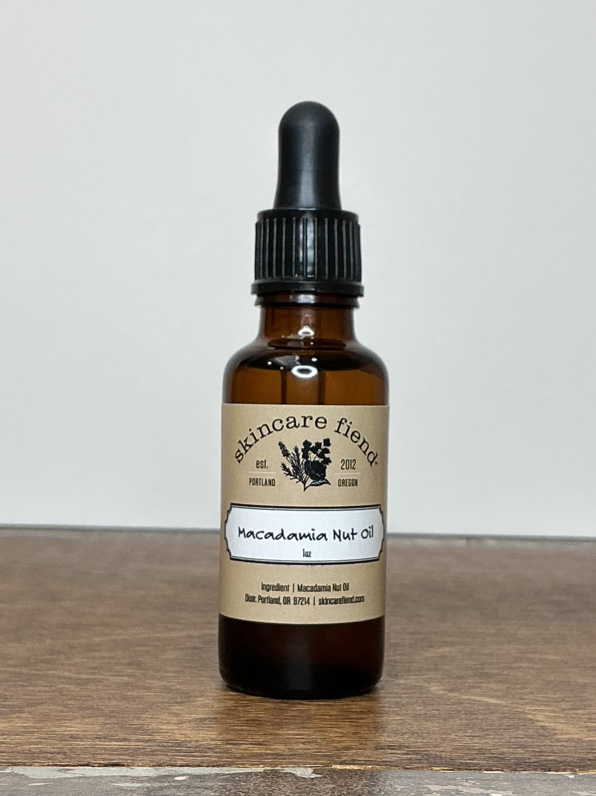skincare fiend bottle of Macadamia Nut Oil on a brown wooden table