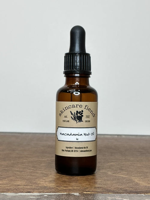 skincare fiend bottle of Macadamia Nut Oil on a brown wooden table